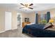 Cozy bedroom with carpet flooring, ceiling fan, and balcony access with natural light at 4102 Plantation Cove Dr # 201, Orlando, FL 32810