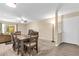Open dining area with wood-look flooring, ceiling fan, and view to the living room at 4102 Plantation Cove Dr # 201, Orlando, FL 32810