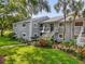 Condo exterior featuring lush landscaping and a private entrance with stairway at 4102 Plantation Cove Dr # 201, Orlando, FL 32810