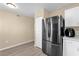 Kitchen area featuring stainless steel refrigerator and access to the dining area at 4102 Plantation Cove Dr # 201, Orlando, FL 32810