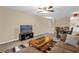 Open-concept living room and dining area with modern furniture and a large TV at 4102 Plantation Cove Dr # 201, Orlando, FL 32810