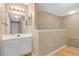 Bathroom with a white vanity, large mirror, and lighting fixtures at 4600 Yellowgold W Rd # 102, Kissimmee, FL 34746
