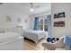 Brightly lit Bedroom featuring a crib, twin bed, blue accents, and cheerful decorations for a cozy feel at 4600 Yellowgold W Rd # 102, Kissimmee, FL 34746