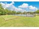 Community bocce ball court and tennis court bordered with grass and well maintained landscaping at 4600 Yellowgold W Rd # 102, Kissimmee, FL 34746