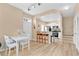 Well-lit kitchen with white cabinets, stainless steel appliances, a breakfast bar, and adjacent dining area at 4600 Yellowgold W Rd # 102, Kissimmee, FL 34746