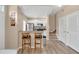 Open kitchen with stainless steel appliances, breakfast bar seating and hardwood floors leads to the upper level at 4600 Yellowgold W Rd # 102, Kissimmee, FL 34746
