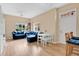 Bright living room with hardwood floors, a plush blue sofa, and a dining area bathed in natural light at 4600 Yellowgold W Rd # 102, Kissimmee, FL 34746