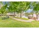 Community pond view with picnic area, grill, dock, and gazebo, perfect for outdoor gatherings at 4600 Yellowgold W Rd # 102, Kissimmee, FL 34746