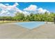 Community tennis court with a well-maintained blue surface, black fence, and benches for relaxing at 4600 Yellowgold W Rd # 102, Kissimmee, FL 34746