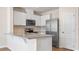 Bright kitchen with white cabinets, granite countertops, and stainless steel appliances at 4602 Linda Dr, Lake Wales, FL 33859