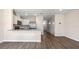 Open concept living space with eat in kitchen and wood-look flooring at 4602 Linda Dr, Lake Wales, FL 33859