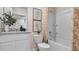 Bright bathroom featuring a white vanity with granite countertop and a shower-tub with floral curtain at 4616 Linda Dr, Lake Wales, FL 33859