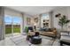 Cozy living room showcasing neutral decor, large windows, and sliding glass doors to backyard at 4616 Linda Dr, Lake Wales, FL 33859