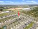Aerial view of a neighborhood with a mix of single-Gathering homes and green spaces at 489 Panaro Ln, Haines City, FL 33844
