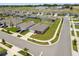 Aerial view of a home with a two car garage and a manicured lawn at 489 Panaro Ln, Haines City, FL 33844
