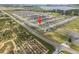 Aerial view of a home in a residential neighborhood, with a lake in the distance at 489 Panaro Ln, Haines City, FL 33844