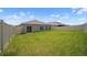 Spacious backyard with lush green grass and a white fence, perfect for outdoor activities at 489 Panaro Ln, Haines City, FL 33844