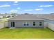 Well-maintained backyard with ample green space and a white fence for privacy, great for outdoor enjoyment at 489 Panaro Ln, Haines City, FL 33844