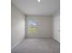 Bedroom with carpet, window and white door at 489 Panaro Ln, Haines City, FL 33844