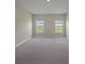 Spacious bedroom with carpet flooring and two windows providing natural light at 489 Panaro Ln, Haines City, FL 33844
