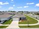 Charming home with well-manicured lawn, complemented by a two-car garage, enhancing curb appeal at 489 Panaro Ln, Haines City, FL 33844