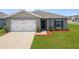 Charming single-story home featuring a well-maintained lawn and attached two-car garage at 489 Panaro Ln, Haines City, FL 33844
