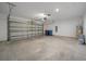 Spacious two-car garage with concrete floors and door, providing ample parking and storage space at 489 Panaro Ln, Haines City, FL 33844