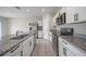 Modern kitchen with granite countertops, stainless steel appliances, and white cabinetry at 489 Panaro Ln, Haines City, FL 33844