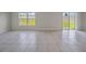 Open concept living area with neutral paint and lots of natural light from the sliding glass door at 489 Panaro Ln, Haines City, FL 33844