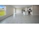 Bright open-concept living space featuring tile floors and a modern kitchen at 489 Panaro Ln, Haines City, FL 33844