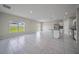 Expansive living area with tile flooring adjacent to a modern kitchen at 489 Panaro Ln, Haines City, FL 33844