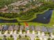 A high aerial view of a home in a lush community next to a pond; perfect for peaceful living at 5161 Dove Tree St, Orlando, FL 32811