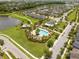 An aerial view showing a community pool with a clubhouse, pool, and surrounding homes at 5161 Dove Tree St, Orlando, FL 32811