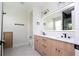 Modern bathroom with dual sinks, illuminated mirror, and sleek black hardware and fixtures at 5161 Dove Tree St, Orlando, FL 32811