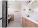 Contemporary bathroom featuring a soaking tub, walk-in shower, and a double sink vanity at 5161 Dove Tree St, Orlando, FL 32811