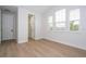 Bright bedroom with luxury vinyl plank flooring, lots of light, and ensuite bathroom at 5161 Dove Tree St, Orlando, FL 32811