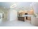 Bright kitchen with light wood cabinetry, quartz counters, stainless appliances, and modern pendant lighting at 5161 Dove Tree St, Orlando, FL 32811