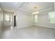 A spacious room with large windows, recessed lighting, and tile flooring, perfect for entertaining at 5161 Dove Tree St, Orlando, FL 32811
