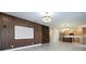 Open-concept living area with wood-look accent wall, decorative lighting, and seamless flow into the kitchen at 5161 Dove Tree St, Orlando, FL 32811