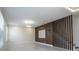 Bright living space featuring a decorative wood accent wall, modern lighting, and a staircase at 5161 Dove Tree St, Orlando, FL 32811