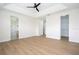 Spacious main bedroom boasting tray ceiling, light wood floors, and access to bathroom and walk-in closet at 5161 Dove Tree St, Orlando, FL 32811