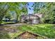 The large backyard with a screened in lanai and mature trees creates a private outdoor retreat at 5430 Baytowne Pl, Oviedo, FL 32765