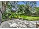 A bench and small plants add to the landscaping elements in the well maintained and private backyard at 5430 Baytowne Pl, Oviedo, FL 32765