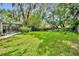 The spacious backyard offers ample green space, mature landscaping, and room for outdoor activities at 5430 Baytowne Pl, Oviedo, FL 32765