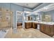 Bathroom featuring double vanity, shower and bath, beige tile and blue walls at 5430 Baytowne Pl, Oviedo, FL 32765