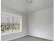 An empty bedroom with gray carpet, white walls and a window at 5430 Baytowne Pl, Oviedo, FL 32765