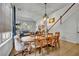 Bright dining room with wood floors and an elegant table with stairs in background at 5430 Baytowne Pl, Oviedo, FL 32765