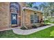 Welcoming front entrance with a blue door, brick facade, and decorative plants at 5430 Baytowne Pl, Oviedo, FL 32765