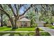 Charming brick home with lush lawn, mature trees, and well-maintained landscaping at 5430 Baytowne Pl, Oviedo, FL 32765
