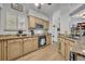 Stylish kitchen featuring granite counters, natural wood cabinets, stainless appliances, and lots of light at 5430 Baytowne Pl, Oviedo, FL 32765